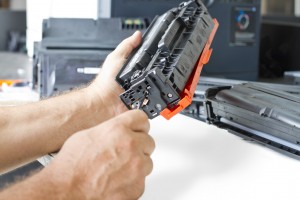 hands repairing toner cartridge